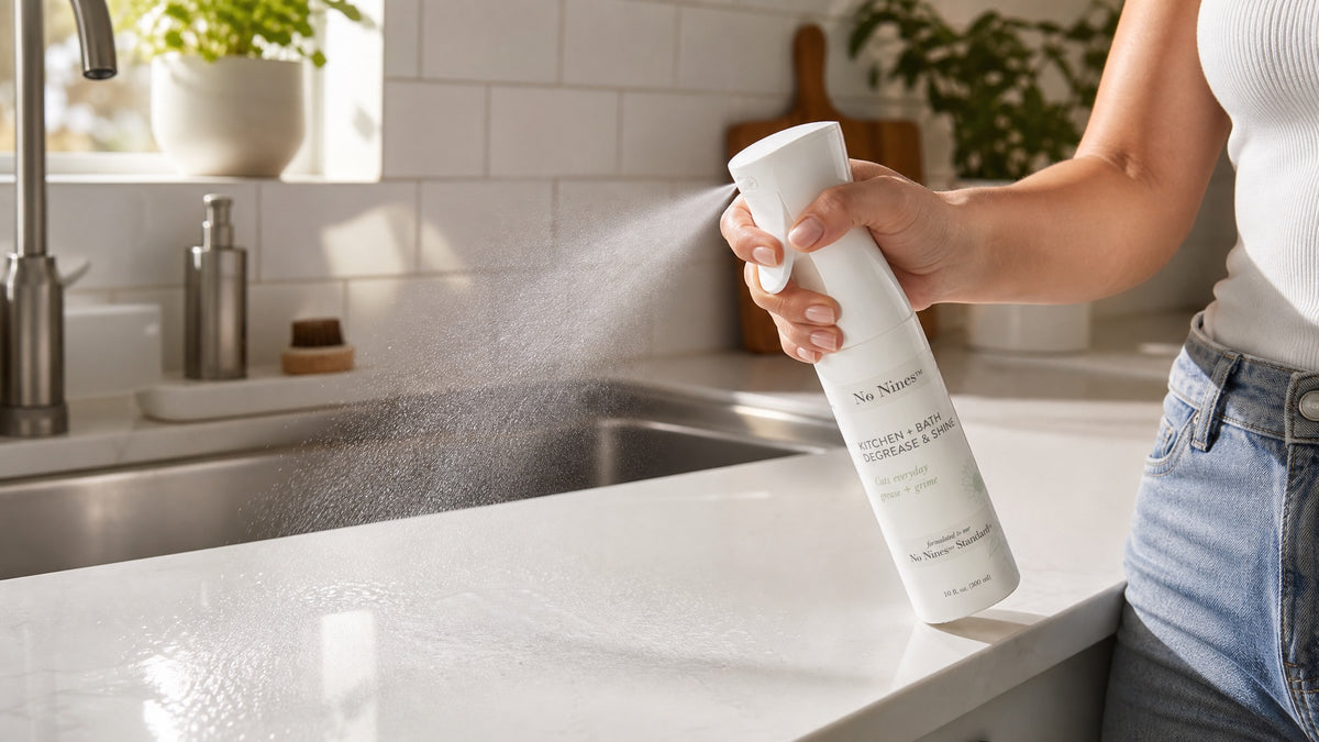Spraying No Nines Kitchen + Bath cleaner on a kitchen counter